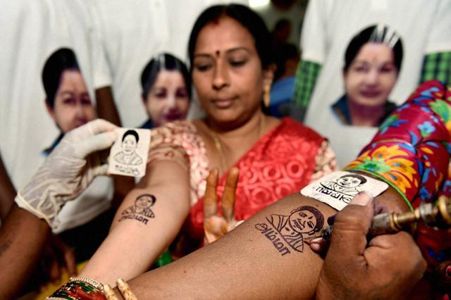 AIADMK cadres getting their hands tattooed with the image of Tamil Nadu chief minister J Jayalalithaa. (PTI) AIADMK cadres getting their hands tattooed with the image of Tamil Nadu chief minister J Jayalalithaa. (PTI)