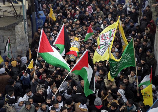 Palestinian mourners carry the body of Khaled Takatka, 21, who was killed during clashes with Israeli troops Friday, during his funeral in the West Bank village of Beit Fajjar, near Bethlehem. (AP Photo) Palestinian mourners carry the body of Khaled Takatka, 21, who was killed during clashes with Israeli troops Friday, during his funeral in the West Bank village of Beit Fajjar, near Bethlehem. (AP Photo)