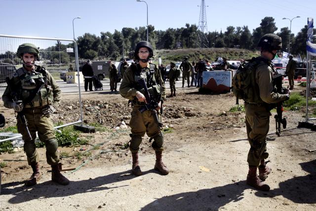 Israeli soldiers stand guard in the West Bank. The defence minister’s comments come after a wave of violence on both sides. (AP Photo) Israeli soldiers stand guard in the West Bank. The defence minister’s comments come after a wave of violence on both sides. (AP Photo)