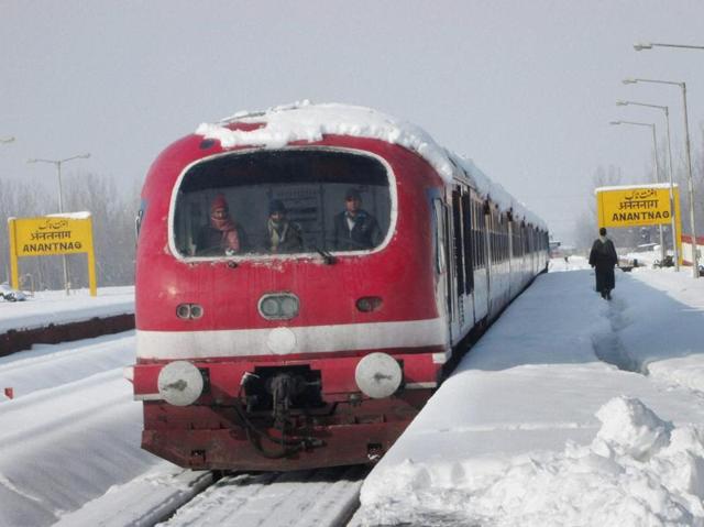 Frozen in track: A train covered in snow is getting ready to leave the Anantnag Railway station. (PTI) 