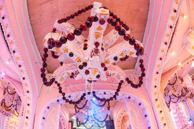 The chandelier is lined with cherries and orange slices, and features a large set of fanged teeth at its core. (Twitter)