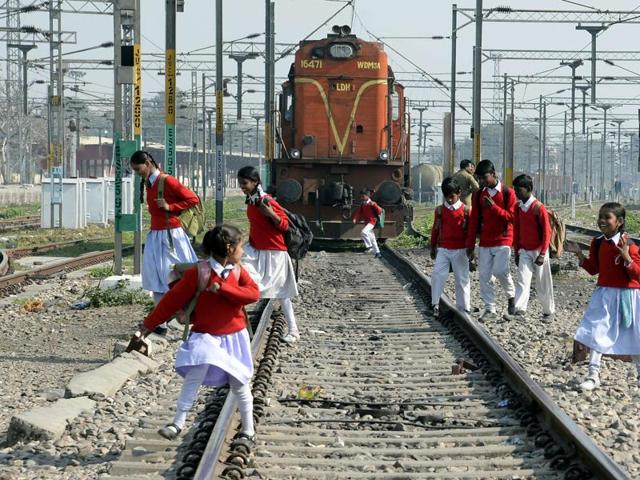 A man walks across a rail track at the Ghaziabad railway station, on the outskirts of New Delhi.(AP Photo)