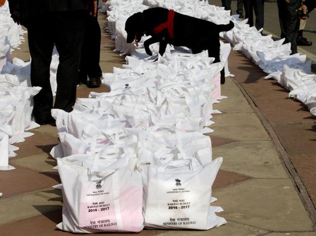 A security sniffer dog sniffs railway budget 2016-17 documents for explosives before they are distributed to the lawmakers inside the Parliament House, in New Delhi.  (AP Photo) 