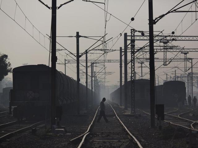 Commuters walk between rail tracks in Ghaziabad train station, on the outskirts of New Delhi. Indian Railways employs close to 1.54 million people, making it the seventh-largest employer in the world, according to Forbes. (AP Photo) 