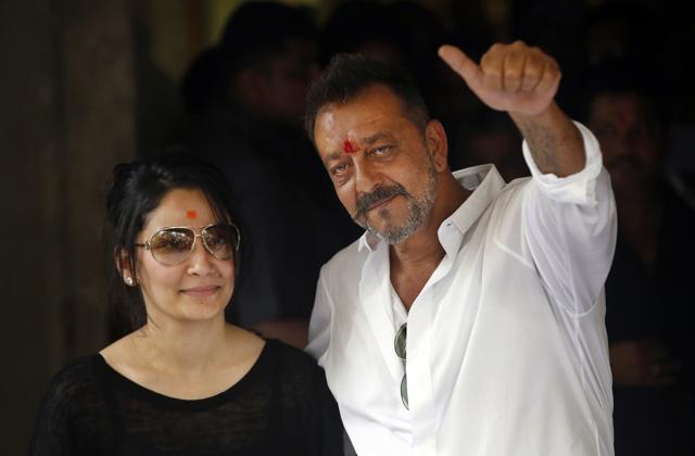Sanjay Dutt, right, shows a thumbs up sign along with his wife Maanyata after arriving at his residence in Mumbai. (AP) Sanjay Dutt, right, shows a thumbs up sign along with his wife Maanyata after arriving at his residence in Mumbai. (AP)
