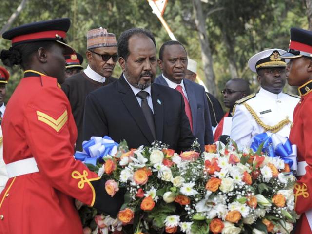 In this Jan. 27, 2016 file photo, Somalia's President Hassan Sheikh Mohamud, center, lays a wreath at an interfaith memorial service honouring Kenyan soldiers killed while on peacekeeping duty in Somalia, at a military barracks in Eldoret, Kenya.(AP)