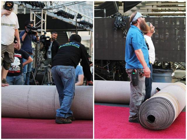 Workers rolling out the massive red carpet for the ceremony. (Facebook) 