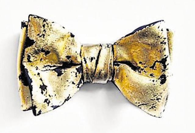 A gold tie, bowtie or a pocket square can also add a dash of sparkle to your look. (Pinterest)