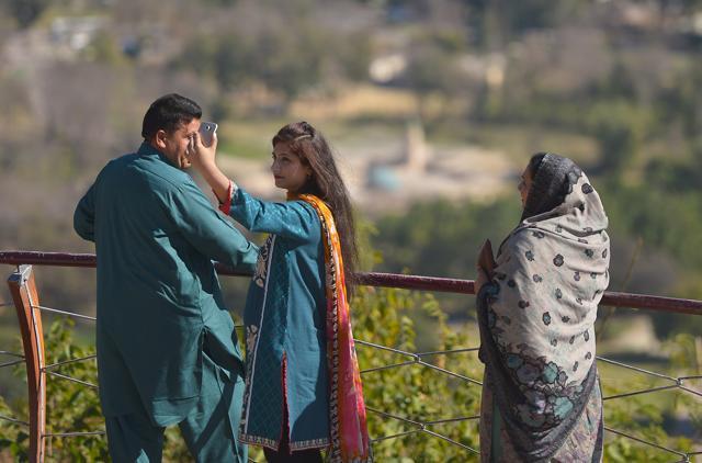 A young Pakistani woman takes a 'selfie' at a Margalla Hills viewpoint in Islamabad. (AFP)