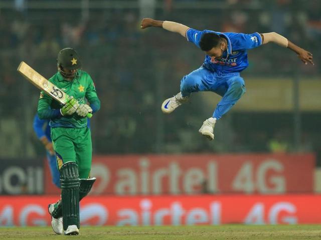 India’s Hardik Pandya (R) jumps in the air in celebration after his dismissal of Shoaib Malik. (AFP Photo) 