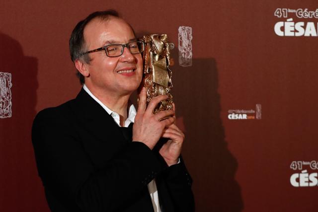 French director Philippe Faucon poses with his trophy during a photocall after he won the Best Feature Film award for Fatima during the 41st edition of the Cesar Ceremony in Paris on February 26, 2016. (AFP)