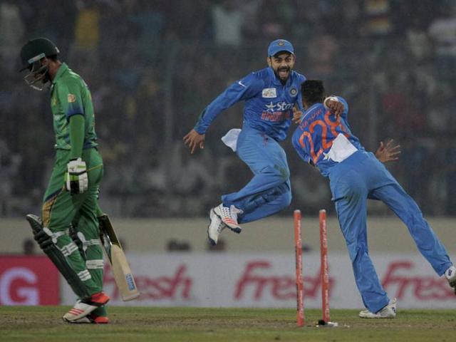 Hardik Pandya, right, celebrates with Virat Kohli, center, after the dismissal of Mohammad Amir, left. (AP Photo) 