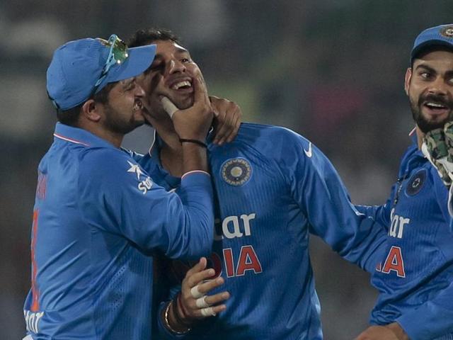 Yuvraj Singh, center, celebrates with Suresh Raina, left, and Virat Kohli after the dismissal of Pakistan’s Umar Akmal. (AP Photo) 