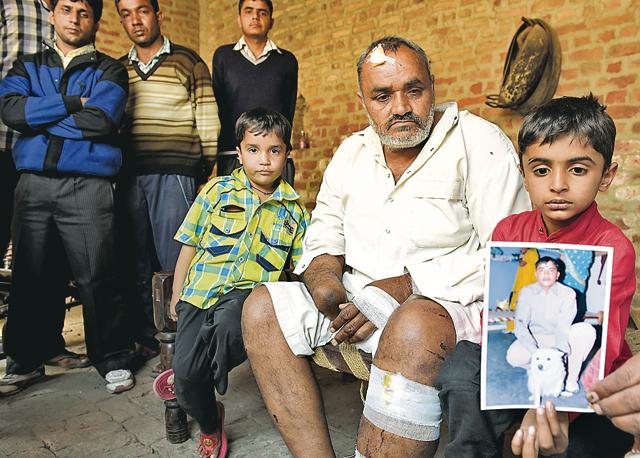 A distraught Satbir with his grandchildren, Priya and Prince, showing the picture of Jaideep in Jhajjar’s Mehrana village. (Sanjeev Sharma/HT) A distraught Satbir with his grandchildren, Priya and Prince, showing the picture of Jaideep in Jhajjar’s Mehrana village. (Sanjeev Sharma/HT)
