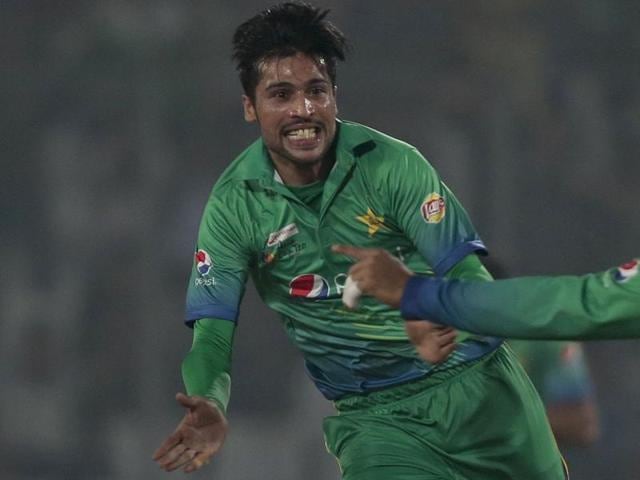 Pakistan’s Mohammad Amir, left, celebrates after the dismissal of India’s Suresh Raina, unseen, during the Asia Cup T20 match in Dhaka on February 27, 2016.(AP)