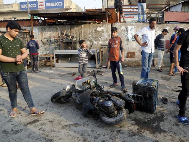 People gather at the site of suicide blasts in Baghdad's Sadr City February 28, 2016. The death toll from two suicide blasts in Baghdad's mainly Shi'ite district of Sadr City rose to 24 with more than 60 others wounded, police and medical sources said on Sunday. (REUTERS) People gather at the site of suicide blasts in Baghdad's Sadr City February 28, 2016. The death toll from two suicide blasts in Baghdad's mainly Shi'ite district of Sadr City rose to 24 with more than 60 others wounded, police and medical sources said on Sunday. (REUTERS)