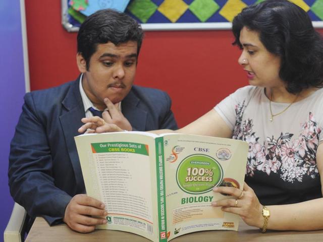 A Class 12 student is getting his doubts cleared from his teacher at the Millennium school in Lucknow on Saturday. (Deepak Gupta/ HT photo)