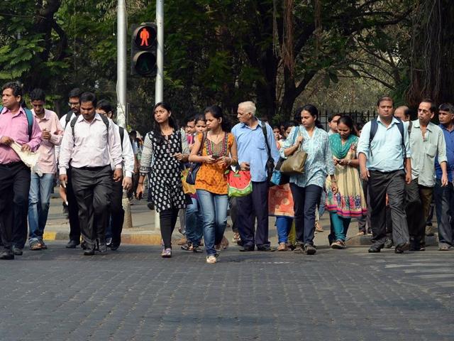 Residents walk at a pedestrian crossing in Mumbai.(AFP)