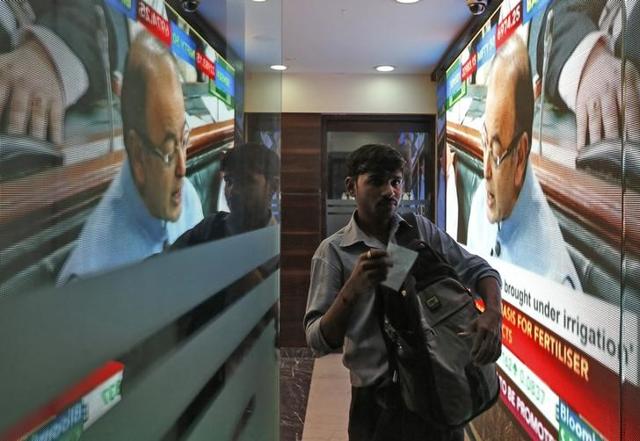 People watch TV at a showroom in Mumbai as Union Finance Minister Arun Jaitley presents the budget 2016-17 in Parliament on Monday. (PTI Photo)