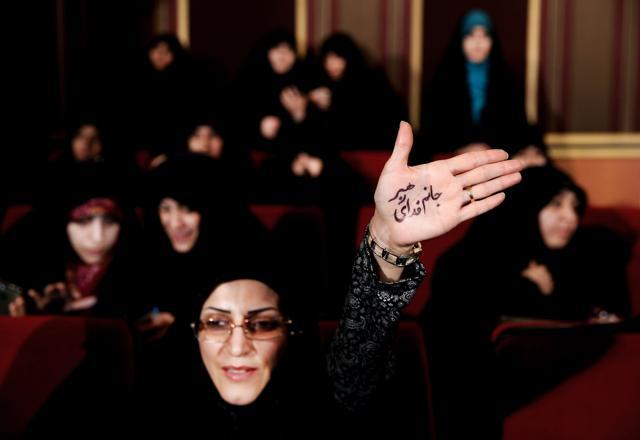 An Iranian hard-liner raises her palm that reads (in Persian), "I'm ready to sacrifice myself for the Supreme Leader," during an anti-British campaign aimed at claiming reformist rivals of being backed by the BBC and the British government, in Tehran, Iran. (AP File Photo) An Iranian hard-liner raises her palm that reads (in Persian), "I'm ready to sacrifice myself for the Supreme Leader," during an anti-British campaign aimed at claiming reformist rivals of being backed by the BBC and the British government, in Tehran, Iran. (AP File Photo)