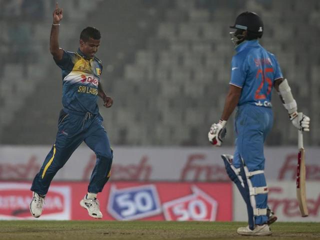 Sri Lanka’s Nuwan Kulasekara, left, celebrates the dismissal of India’s Shikhar Dhawan, right. (AP Photo) 