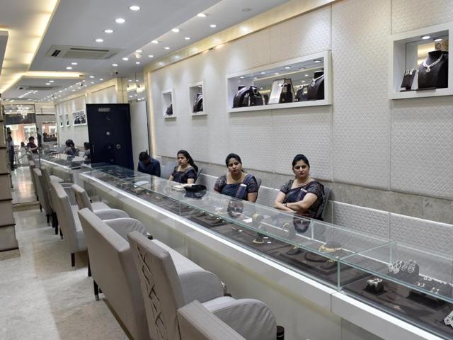 Employees of a jewellery showroom in Delhi wait for customers. Finance minister Arun Jaitley has proposed to reintroduce a one-percent levy on some jewellery transactions, angering the industry. (Ravi Choudhary/HT Photo) Employees of a jewellery showroom in Delhi wait for customers. Finance minister Arun Jaitley has proposed to reintroduce a one-percent levy on some jewellery transactions, angering the industry. (Ravi Choudhary/HT Photo)