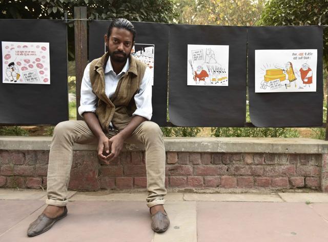 Cartoonist Gopal Shonya with his creations on display on the grills of Park in Front of Admin Block at JNU Campus. (Vipin Kumar/ Hindustan Times) Cartoonist Gopal Shonya with his creations on display on the grills of Park in Front of Admin Block at JNU Campus. (Vipin Kumar/ Hindustan Times)