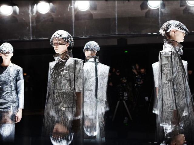Anrealage: Last season, this label’s clothes revealed hidden color when flashed by cameras and smartphones. For autumn/winter 2016, Anrealage is back with another futuristic, technology-inspired collection themed around “Noise.” The collection used various shades of gray, sometimes revealing stripes and checks. (March 1, 2016). (AFP) 