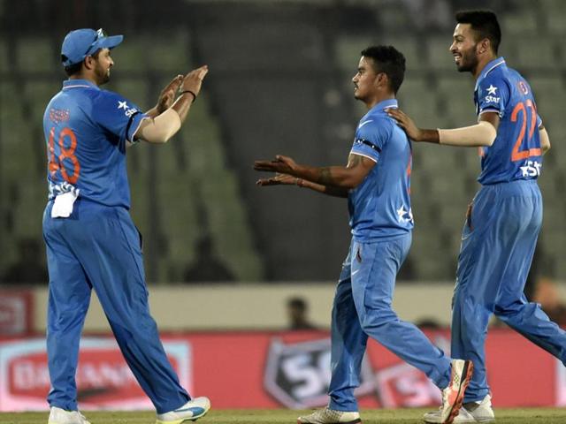 Indian cricketer Suresh Raina  and Hardik Pandya  congratulate teammate Pawan Negi. (AFP Photo) 