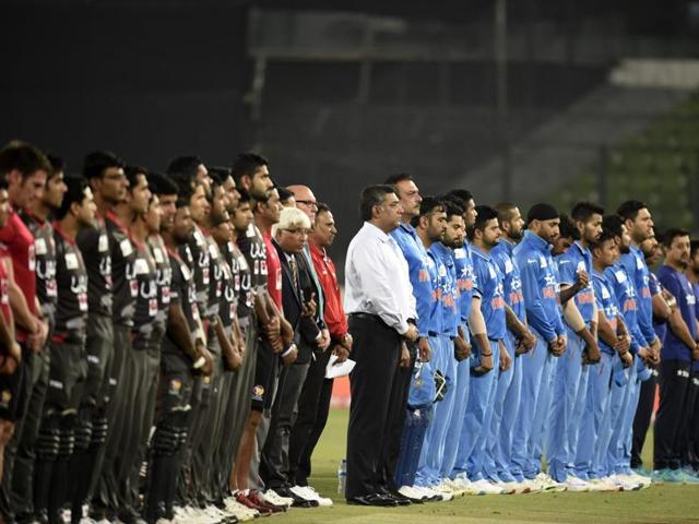 United Arab Emirates and India cricketers stand in a moment of silence for former New Zealand captain Martin Crowe. (AFP Photo) 