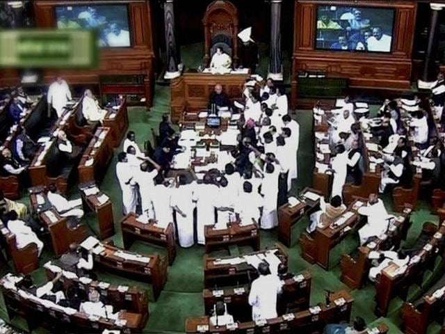 AIADMK members protest in the well of Lok Sabha in New Delhi on Wednesday. (PTI) AIADMK members protest in the well of Lok Sabha in New Delhi on Wednesday. (PTI)