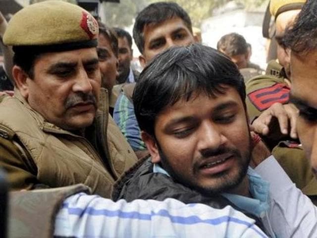 A policeman tries to save a JNU student who was being beaten up during a clash between the advocates and the students outside the Patiala House Courts in New Delhi . The clash broke out after a protest by the students against the arrest of JNU student leader Kanhaiya Kumar. (PTI File Photo)