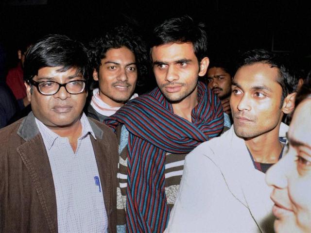 Jawaharlal Nehru University students Umar Khalid (C) and Anirban Bhattacharya (R) at the JNU campus, in new Delhi.(PTI File Photo)