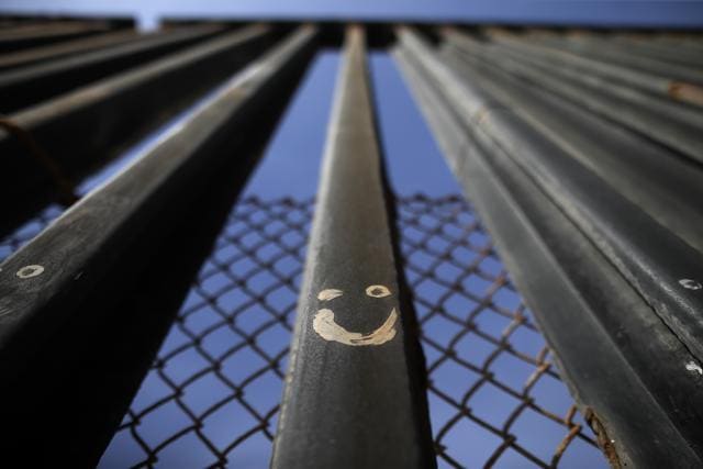 Graffitti adorns metal bars marking the United States border where it meets the Pacific Ocean in Tijuana, Mexico. (AP) Graffitti adorns metal bars marking the United States border where it meets the Pacific Ocean in Tijuana, Mexico. (AP)