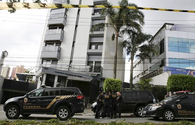 Federal police officers stand in front of the apartment building that former Brazilian President Luiz Inacio Lula da Silva lived in Sao Bernardo do Campo, Brazil, March 4, 2016. (REUTERS) Federal police officers stand in front of the apartment building that former Brazilian President Luiz Inacio Lula da Silva lived in Sao Bernardo do Campo, Brazil, March 4, 2016. (REUTERS)