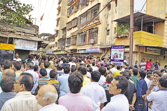 People gather outside Nayan Jain’s house at Gandhi Chowk in Kalyan on Thursday. (Rishikesh Chaudhary)