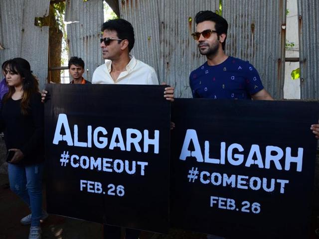 Actors Rajkummar Rao and Manoj Bajpai hold banners of their upcoming movie ‘Aligarh’ during a promotional event in Mumbai. (IANS File Photo)