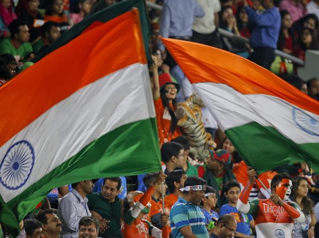 Indian spectators wave their national flags. (AP Photo) Indian spectators wave their national flags. (AP Photo)