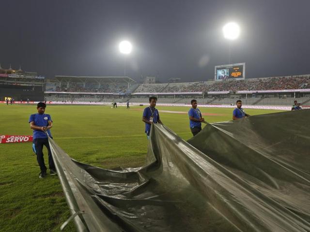 Bangladeshi ground staff pull covers on the field as it rains ahead of the Asia Cup Twenty20 international cricket final match. (AP Photo) Bangladeshi ground staff pull covers on the field as it rains ahead of the Asia Cup Twenty20 international cricket final match. (AP Photo)