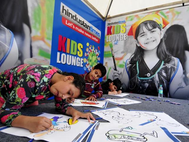 Kids enjoy colouring and drawing with free kits at the Palate Fest in Chandigarh on Saturday.(Ravi Kumar/HT Photo)