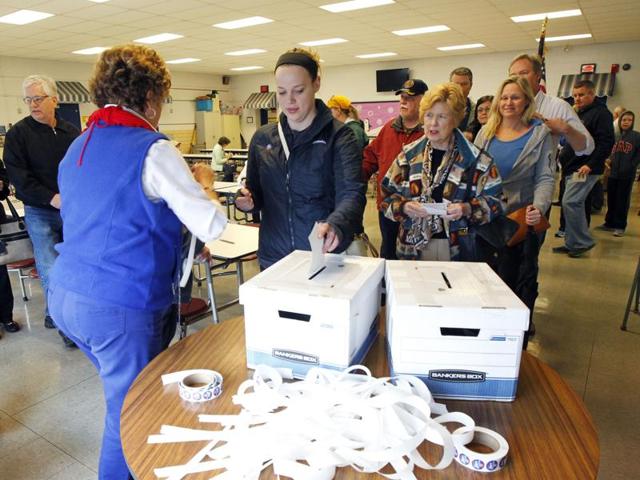 Kentucky voters place their paper ballots in voting box in the GOP presidential caucus at Zachary Taylor Elementary school. (AFP) Kentucky voters place their paper ballots in voting box in the GOP presidential caucus at Zachary Taylor Elementary school. (AFP)