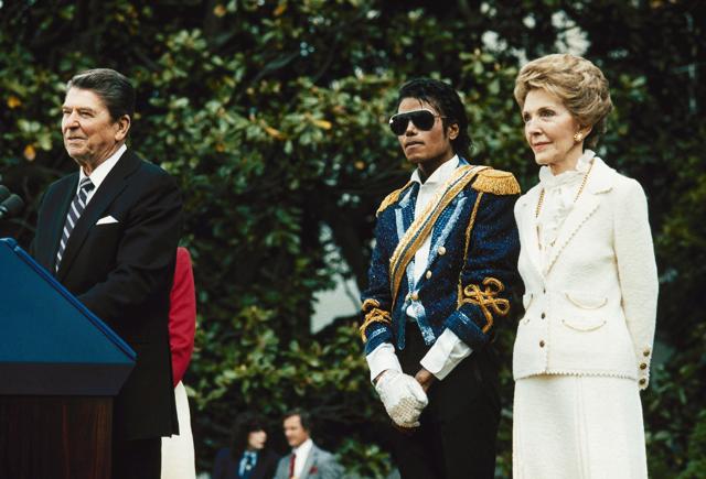 Michael Jackson, centre, stands with President Ronald Reagan, left, and First Lady Nancy Reagan on the south lawn of the White House prior to receiving an award from the President for his contribution to the drunk driving awareness program. (AP Photo)