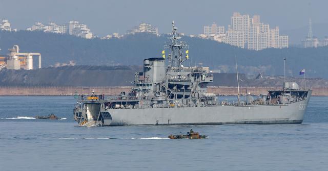 South Korean Marine amphibious assault vehicles move to a landing ship (centre) in the southeastern port of Pohang on Monday after South Korea and the US kicked off their largest-ever joint military drills. (AFP)
