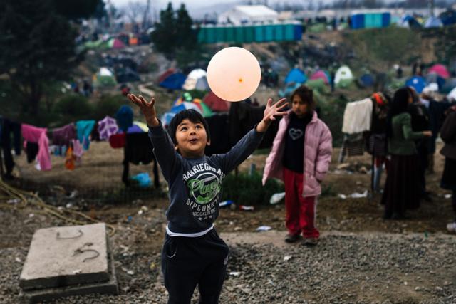 A child plays with a ballon in a makeshift camp at the Greek-Macedonian border near the Greek village of Idomeni. (AFP) A child plays with a ballon in a makeshift camp at the Greek-Macedonian border near the Greek village of Idomeni. (AFP)