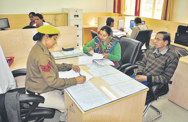 Women police personnel attend to complaints. (HT Photo) Women police personnel attend to complaints. (HT Photo)