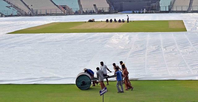 Groundsmen engage in final preparations of the pitch at Eden Gardens in Kolkata ahead of ICC World Twenty20. (PTI Photo) 