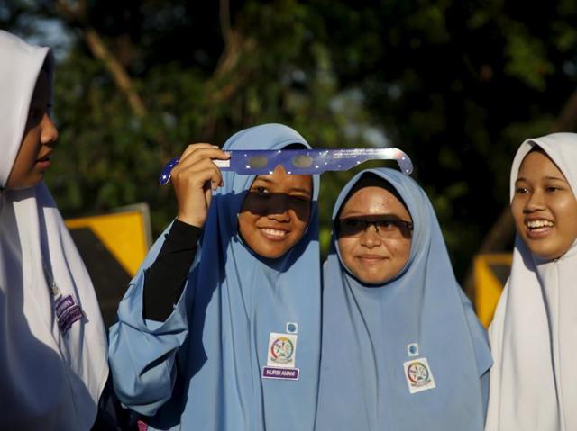 School children watch a partial solar eclipse at the Planetarium in Kuala Lumpur, Malaysia on Wednesday. (Reuters)