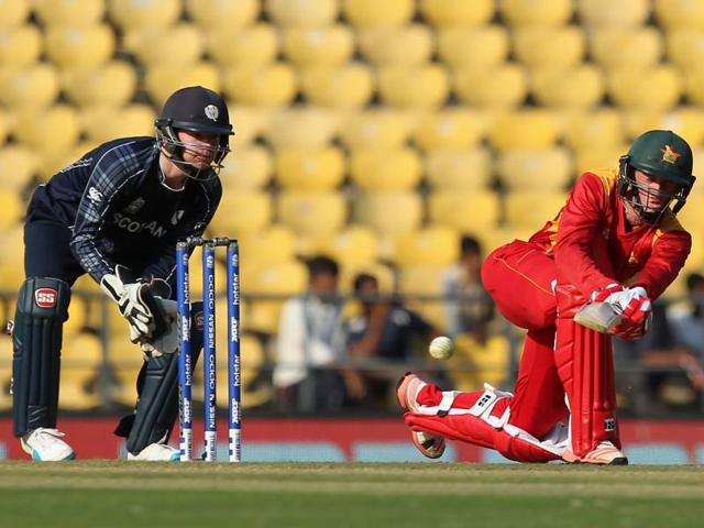 Sean Williams of Zimbabwe plays a shot as Scotland's Matt Cross looks on. (AFP Photo)