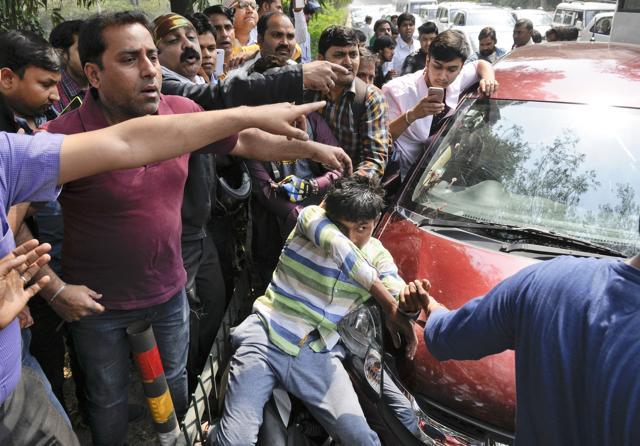 The attacker nabbed by passersby after the crime. (Burhaan Kinu/HT Photo) The attacker nabbed by passersby after the crime. (Burhaan Kinu/HT Photo)