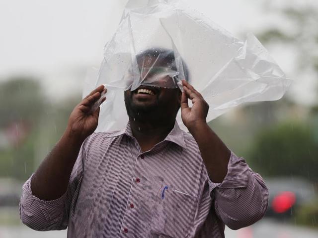 A man covering his head with a plastic bag enjoys walking in the rain in Dubai, United Arab Emirates. (AP) A man covering his head with a plastic bag enjoys walking in the rain in Dubai, United Arab Emirates. (AP)